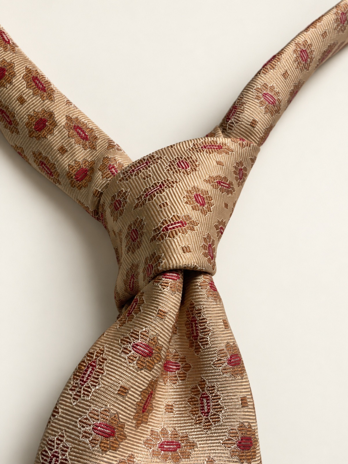 A four-in-hand knot in a woven silk tie