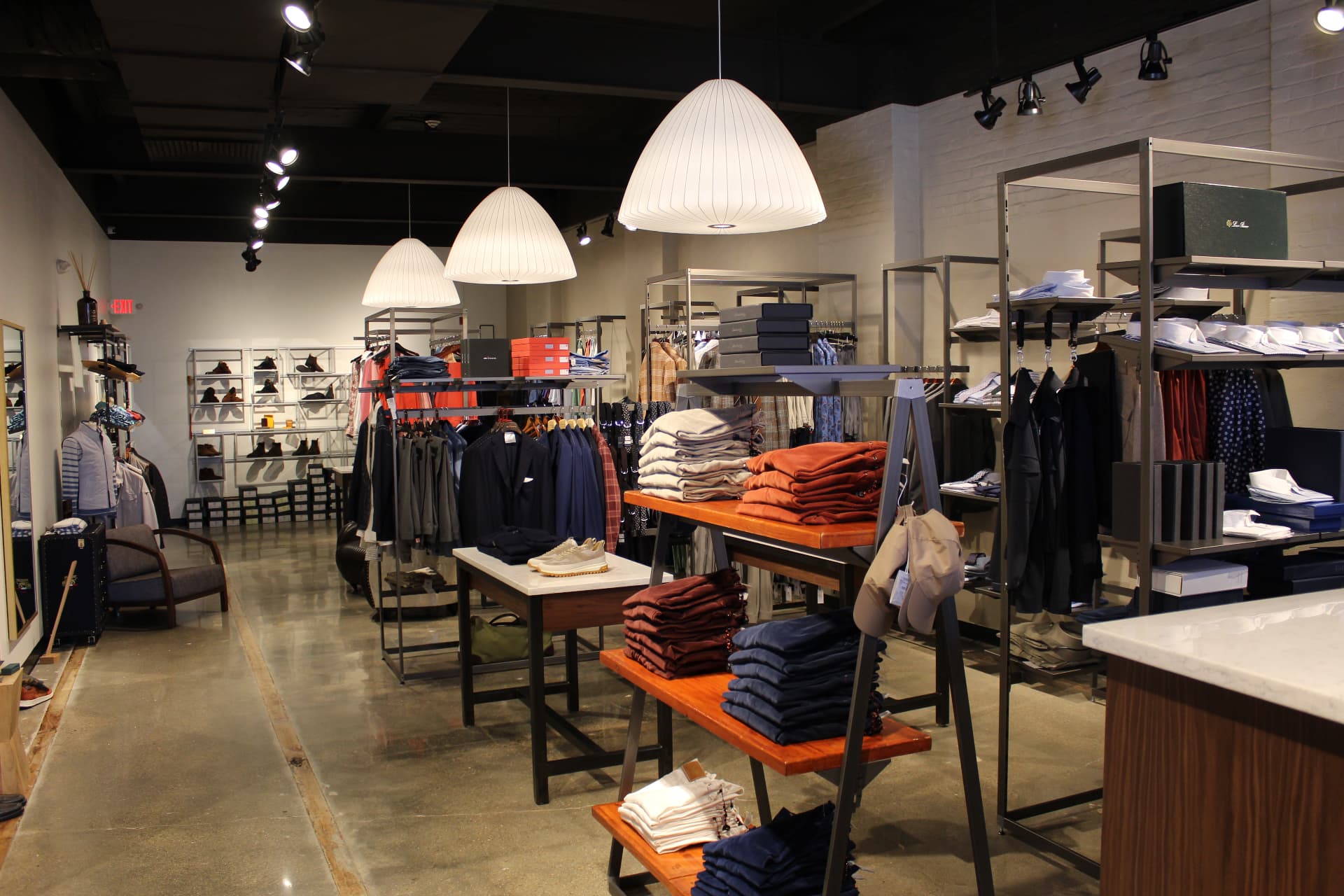 The Marc Allen shop floor with folded knitwear, shirts, and tailoring
