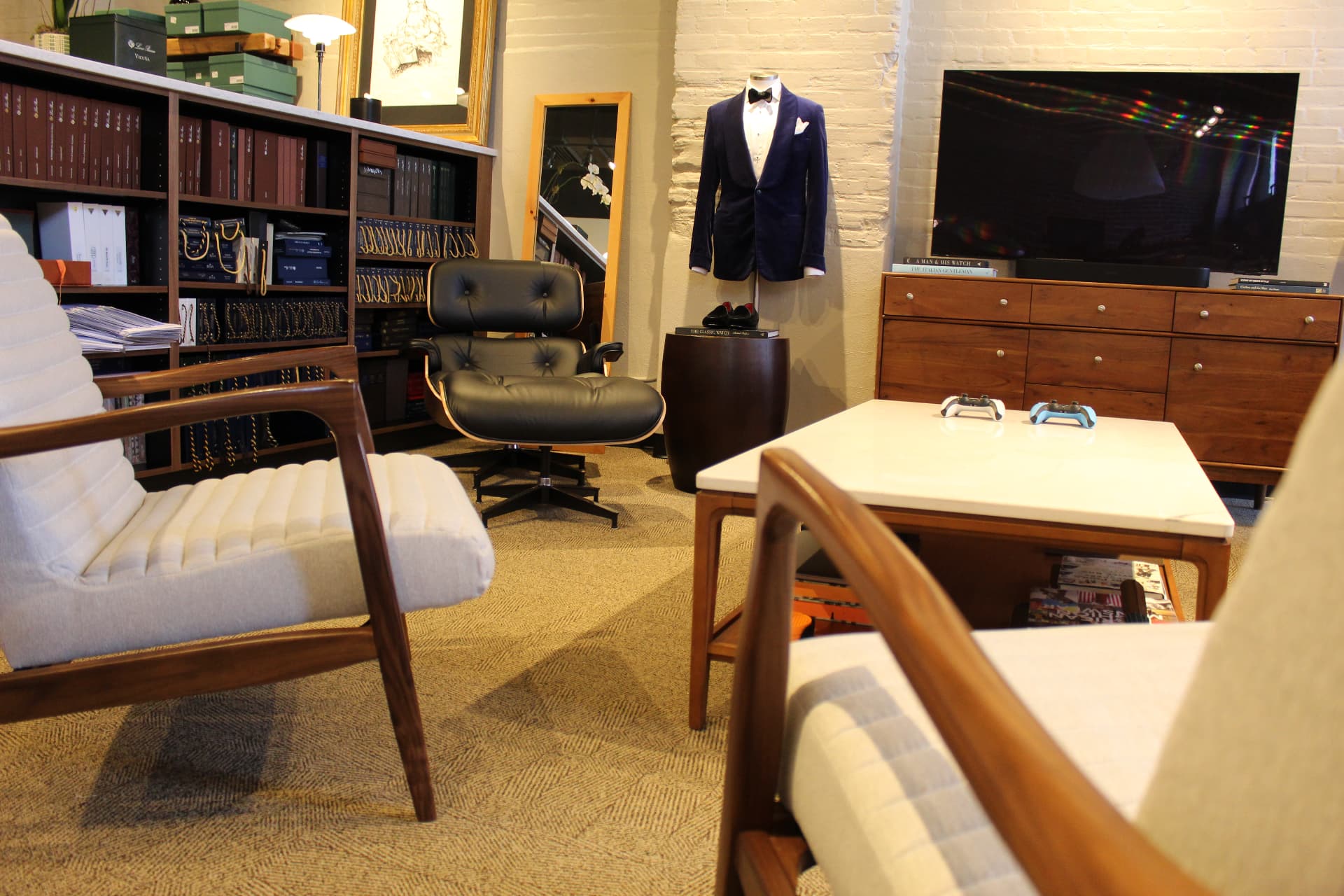 The lounge at Marc Allen with modern chairs and a tailored dinner jacket