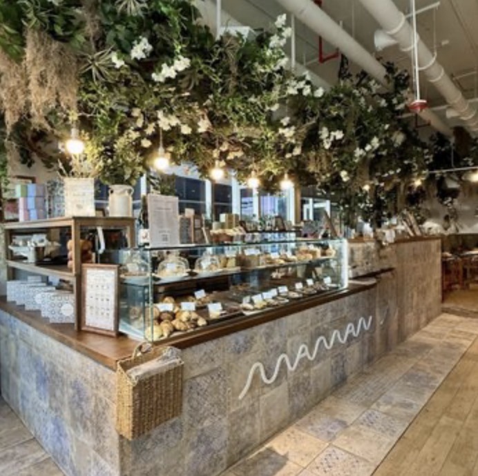 Maman bakery pastry counter with hanging greenery