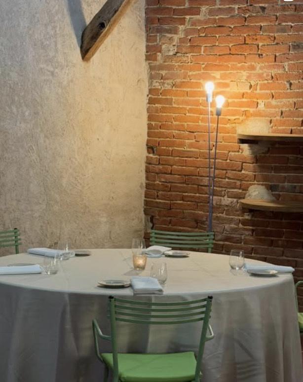 Bare brick, lime plaster, a single standing lamp