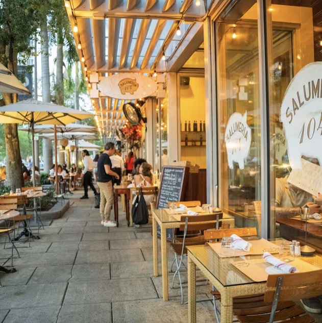 Salumeria 104 sidewalk terrace in Midtown Miami at golden hour